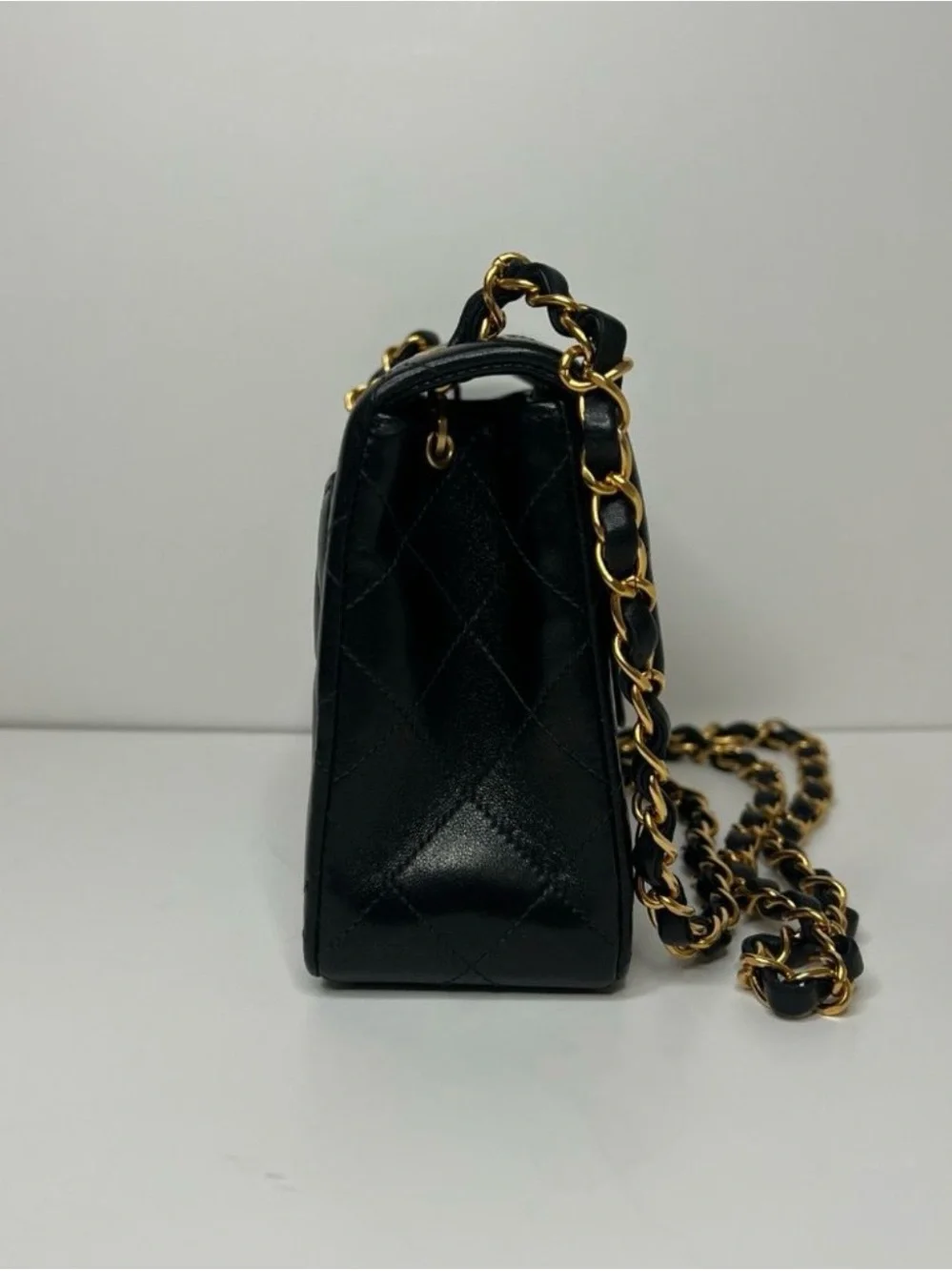 CHANEL Black Quilted Leather Mini Flap Bag with Gold Chain